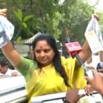 On way to ED office, BRS’ K. Kavitha waves bags full of mobile phones she used in the past